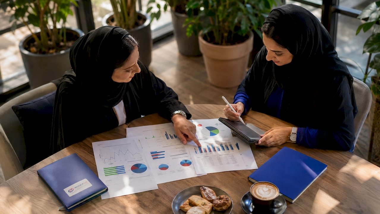 Two women discussing ERP licensing in lounge