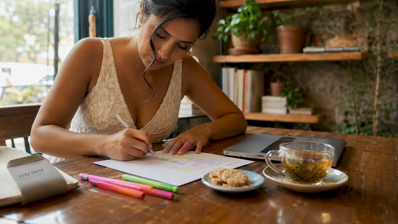 Bride planning wedding timeline at home office