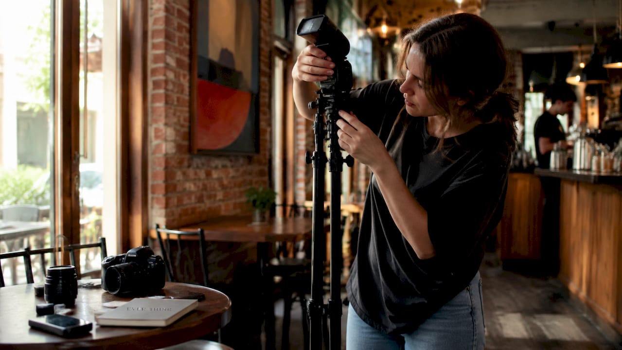 Photographer adjusting studio lighting setup