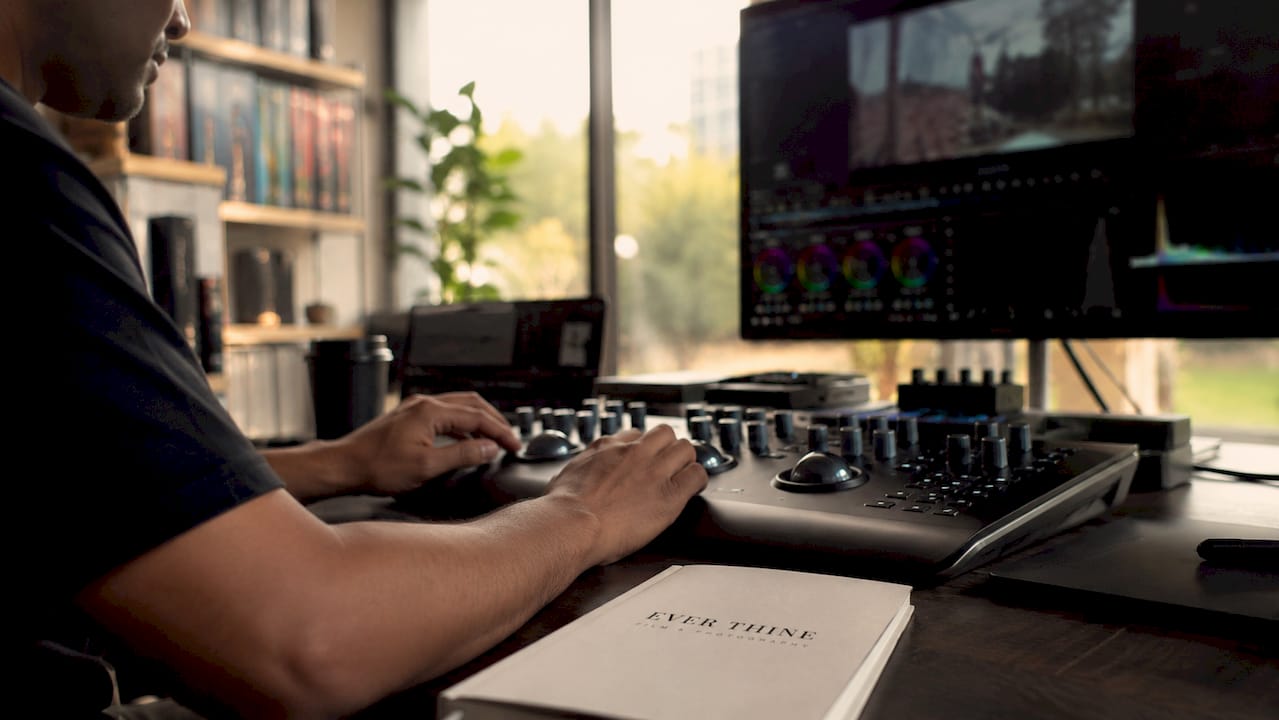 Hands adjusting colour correction tools on console
