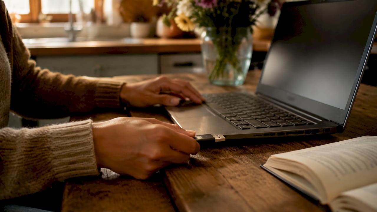 Hands inserting USB for photo quality preservation