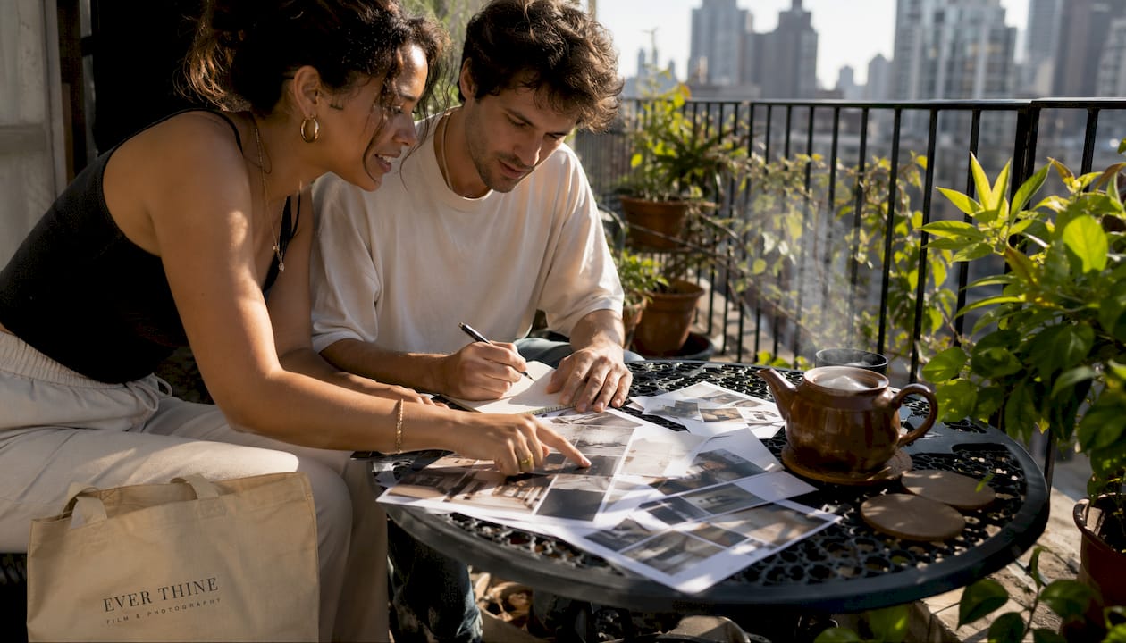 Couple preparing photography brief at table