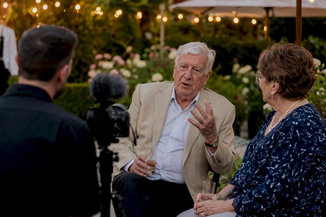 Videographer recording guest interview at wedding