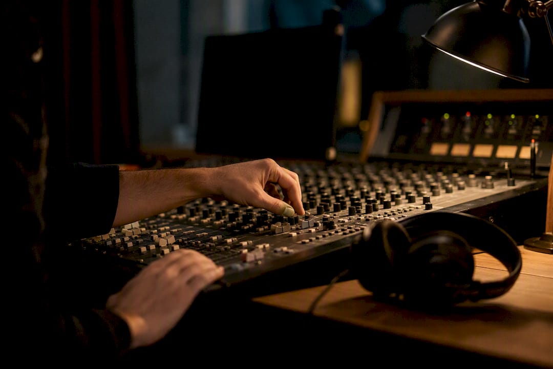 Hands mixing music for wedding film