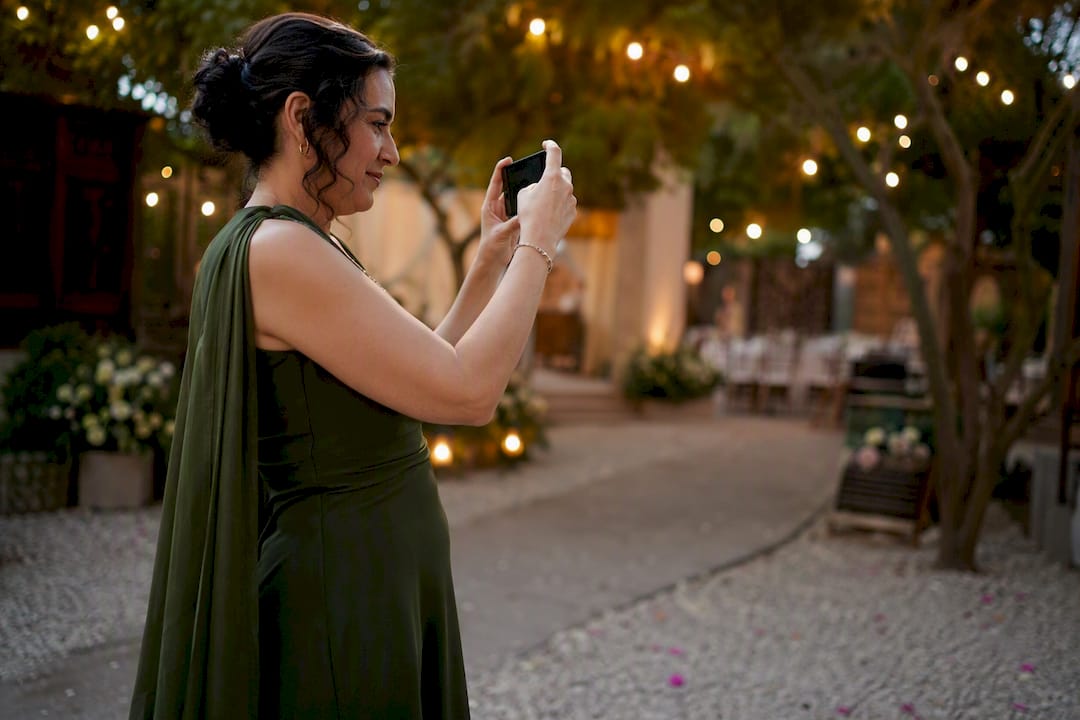 Wedding guest holding phone quietly