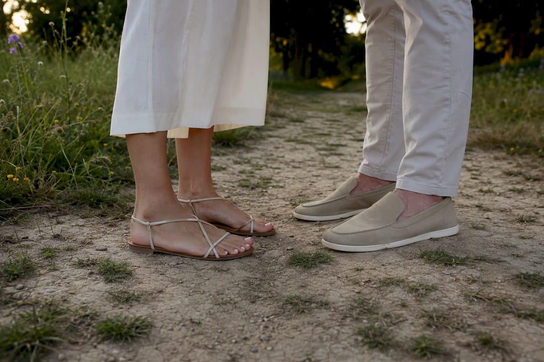 Couple's comfortable footwear on grassy ground