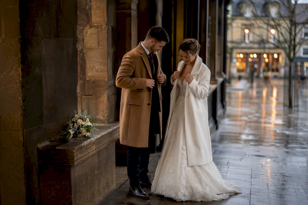 Newlyweds taking portraits after rain