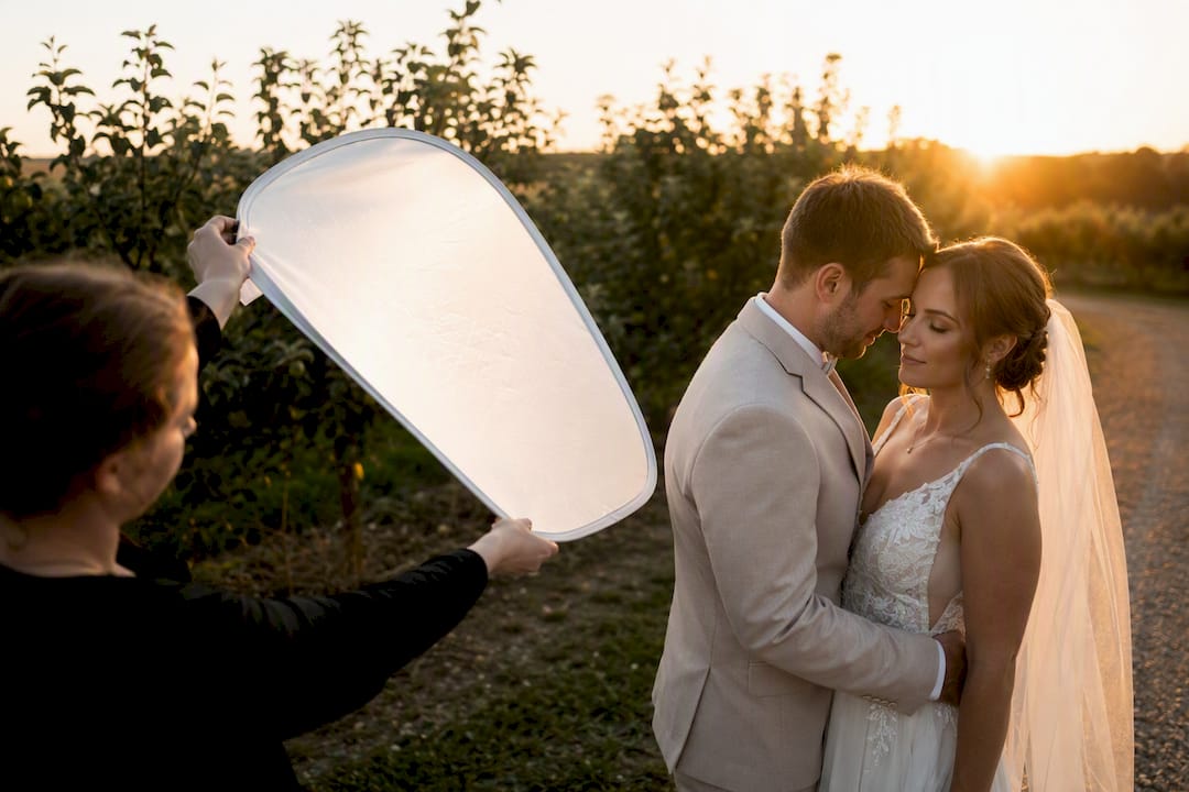 Reflector lifting light onto wedding couple