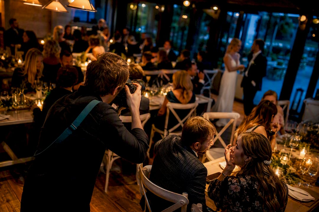 Photographer capturing candid wedding reception moments