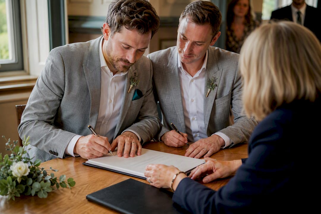 Partners signing civil partnership schedule