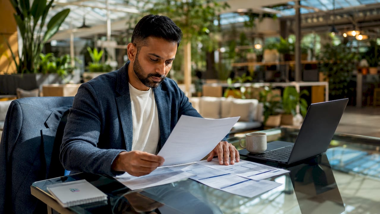 Company director reviewing salary and dividend paperwork