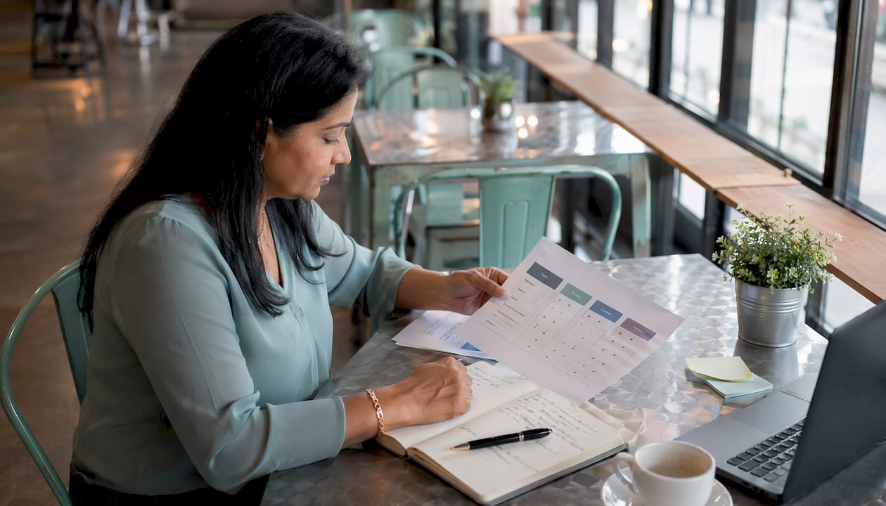 Business owner reviewing pricing plans at desk