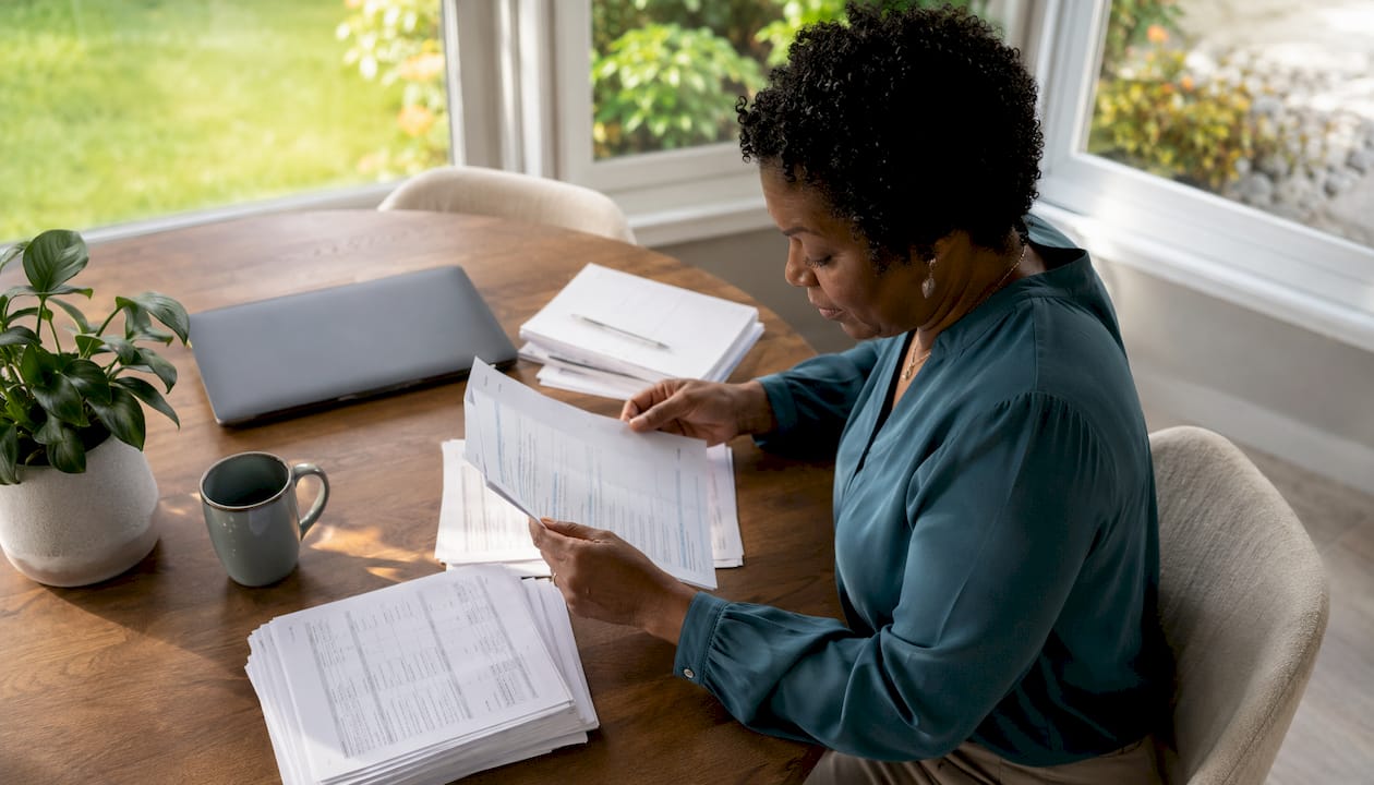 Business owner reviewing printed tax documents