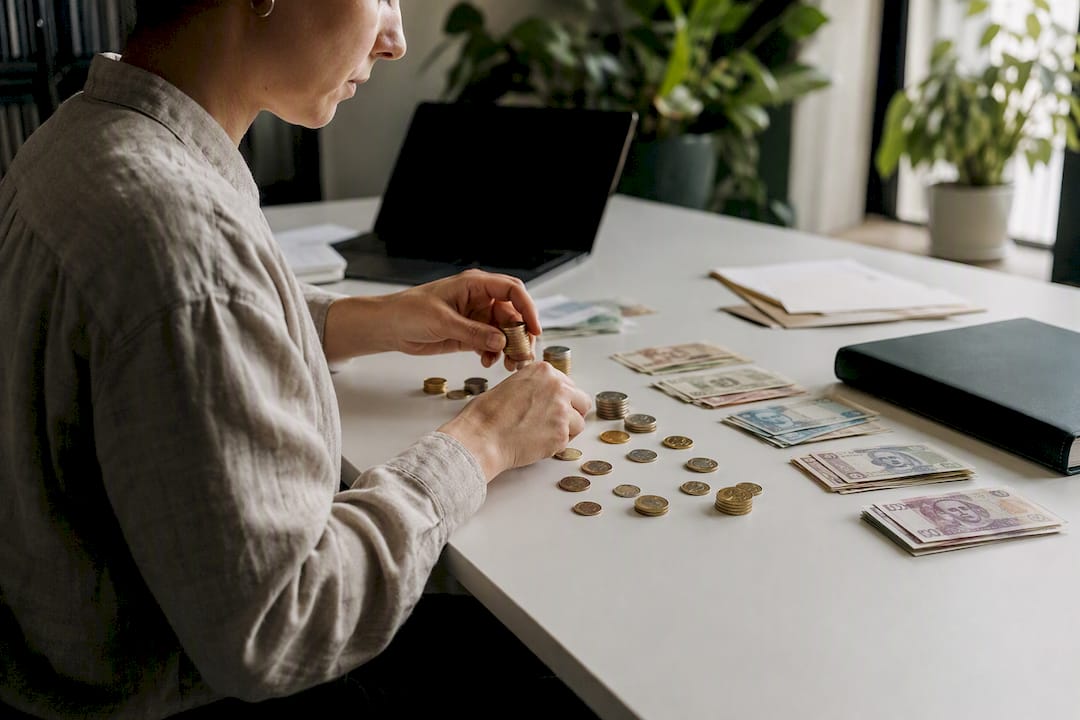Hands sorting money and calculator close-up
