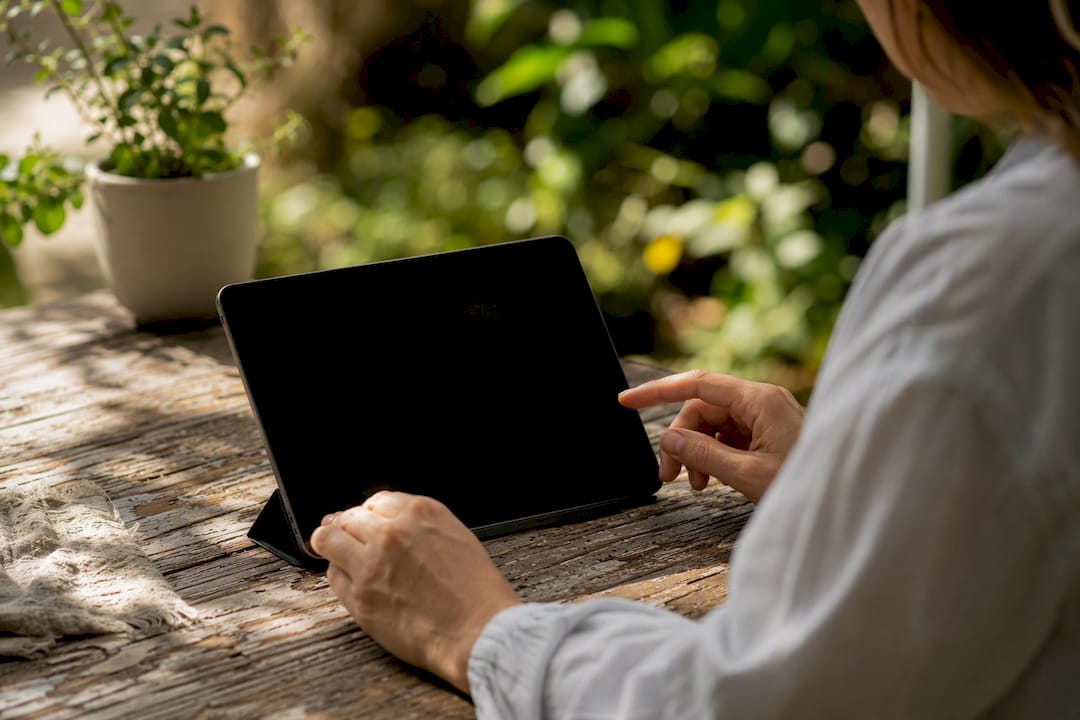 Hands sorting digital receipts on tablet device