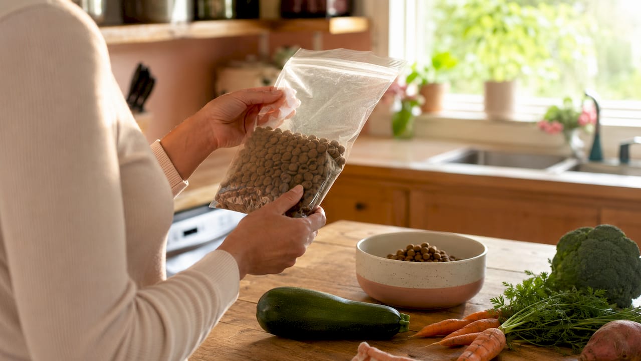 Hands reading dog food nutrition label carefully