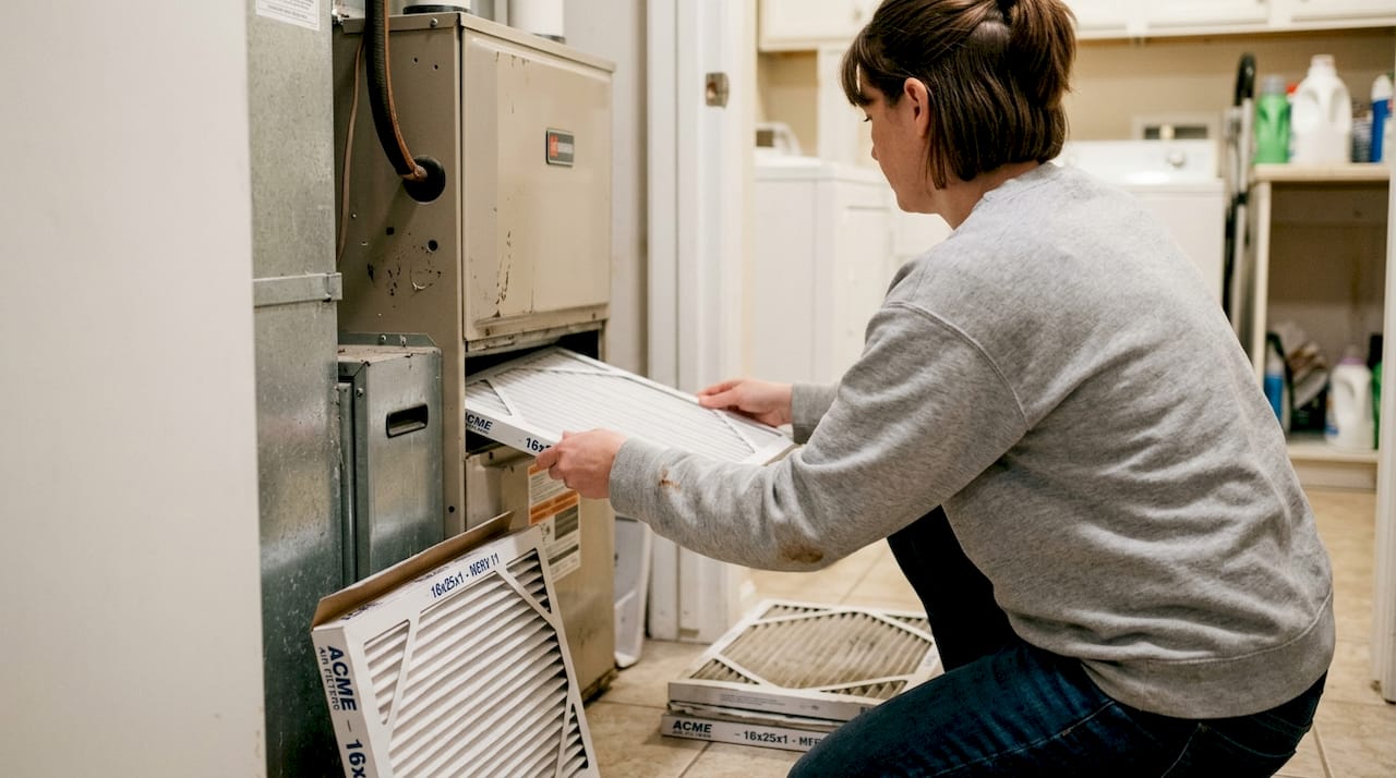 Woman changing home HVAC air filter