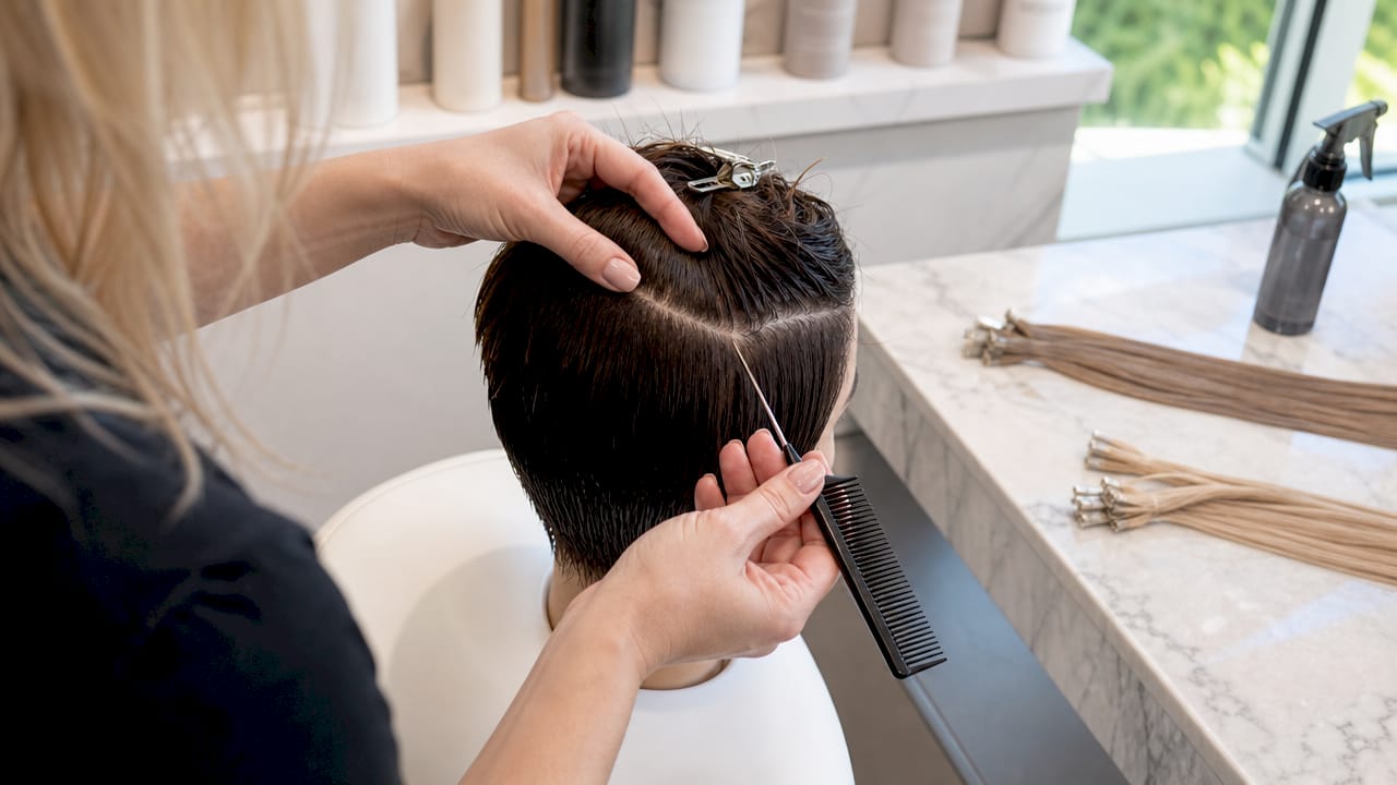 Hands sectioning short hair in salon