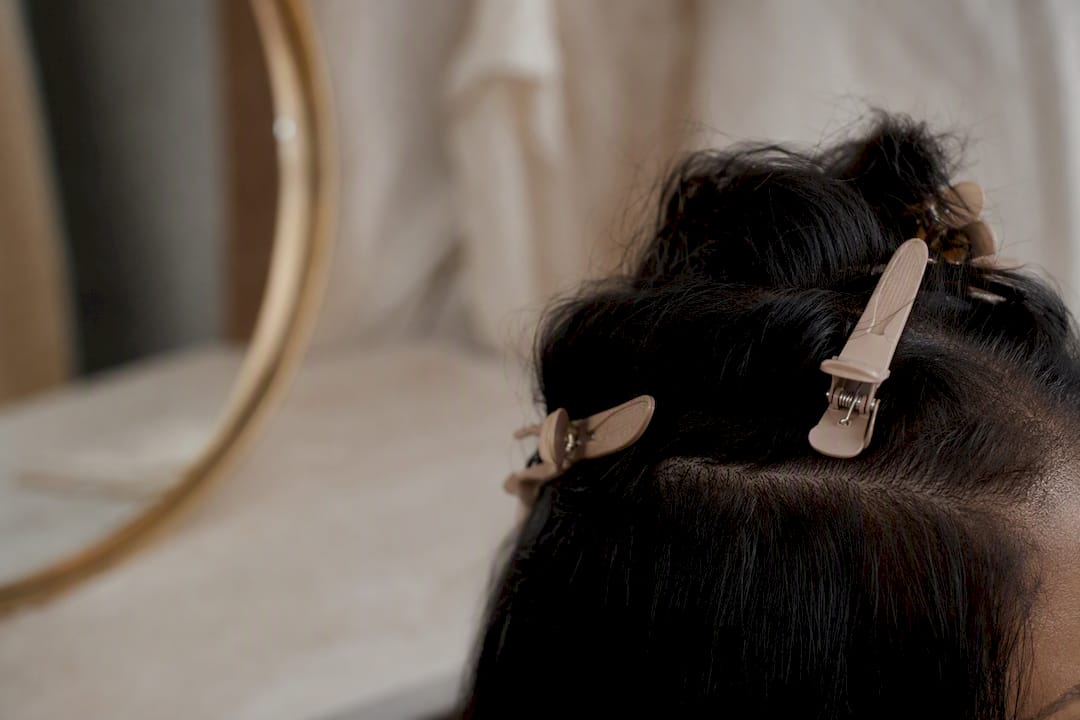 Close-up of clip-in extension clips gripping hair