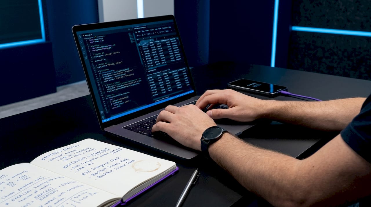 Hands working on financial data preparation on laptop