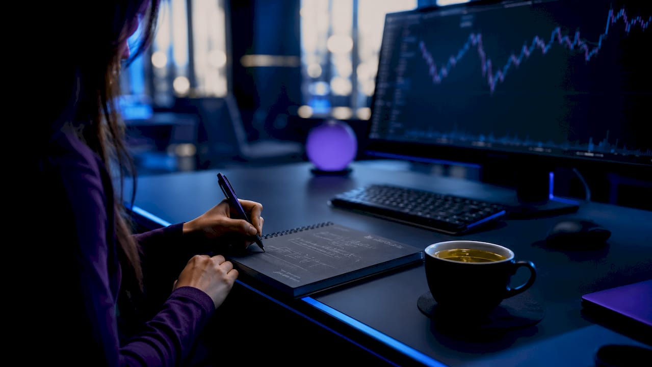 Hands calculating stop-loss levels in crypto trading
