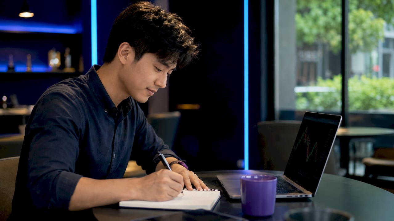 Trader using AI tools at home desk early morning