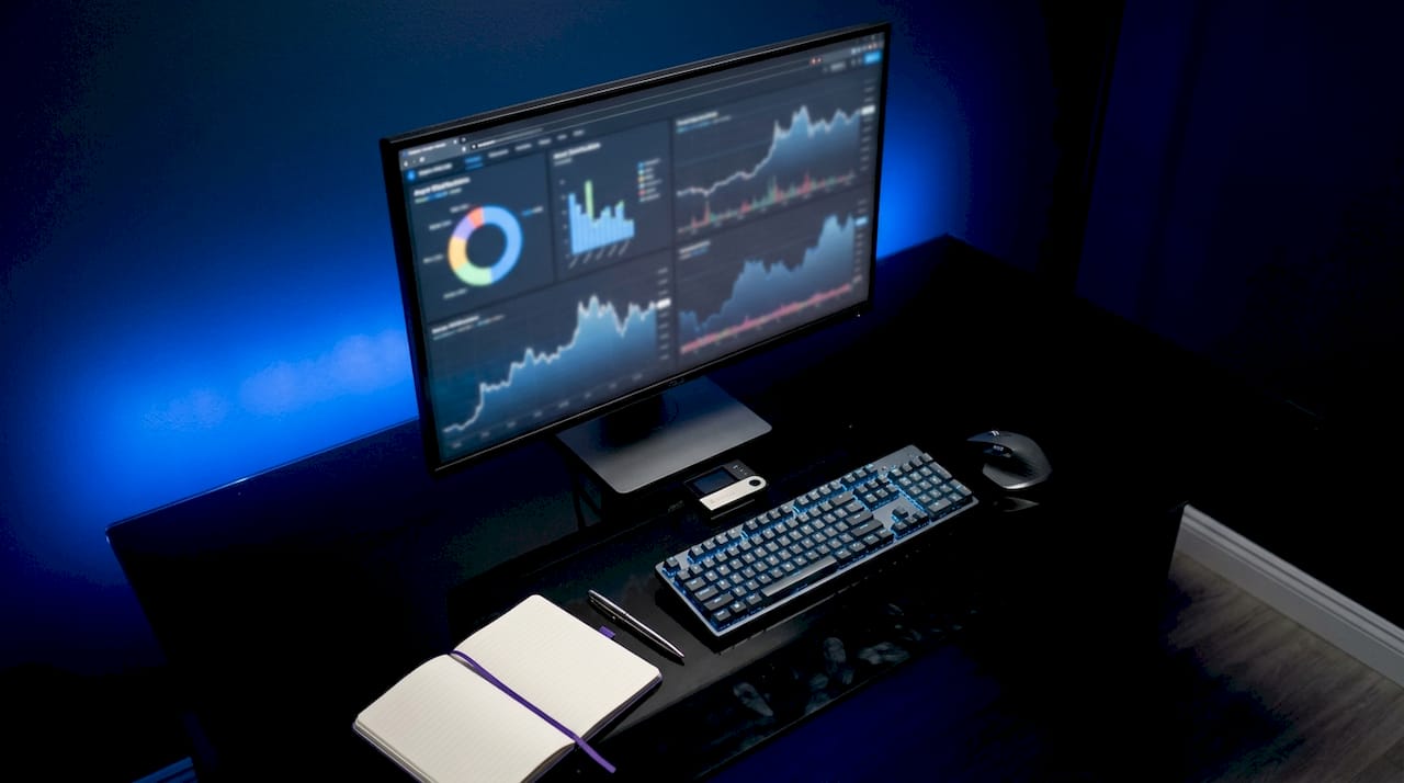 Dark fintech desk with crypto charts and tools