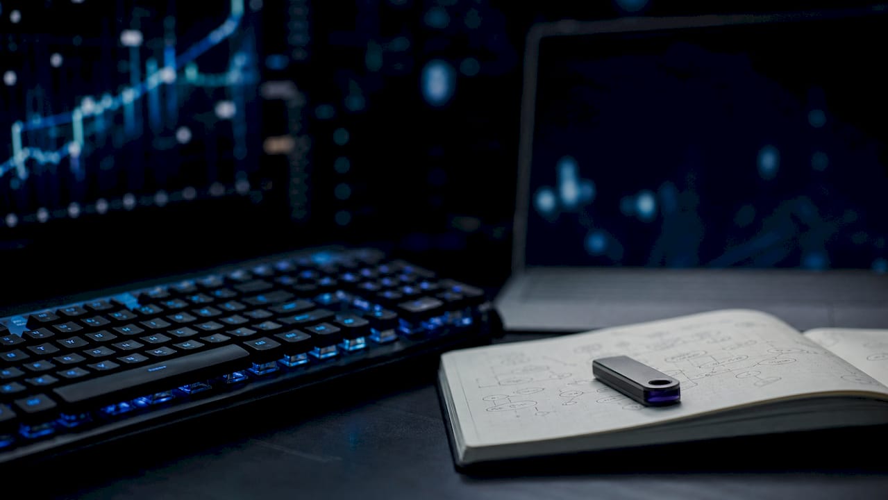 Hands typing on keyboard in crypto trading workspace