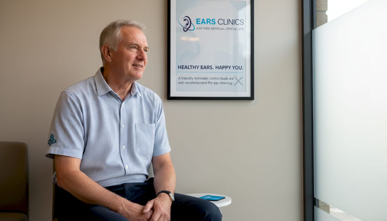 Man reads caution sign about cotton buds