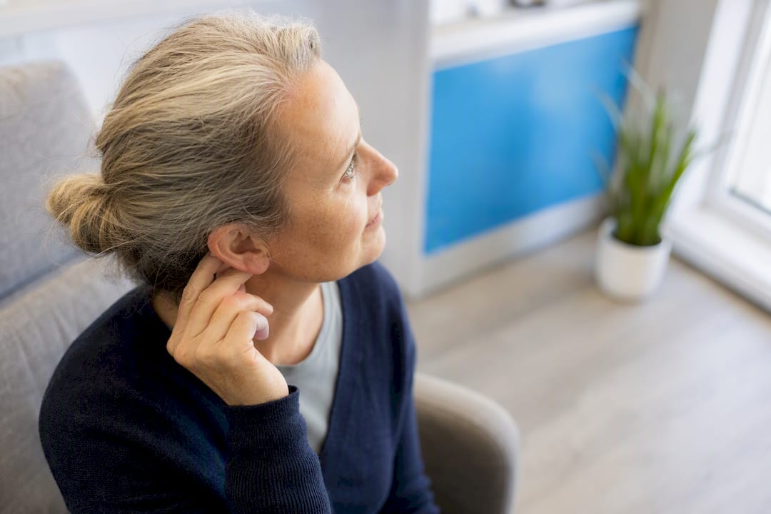 Hand near ear in clinic environment