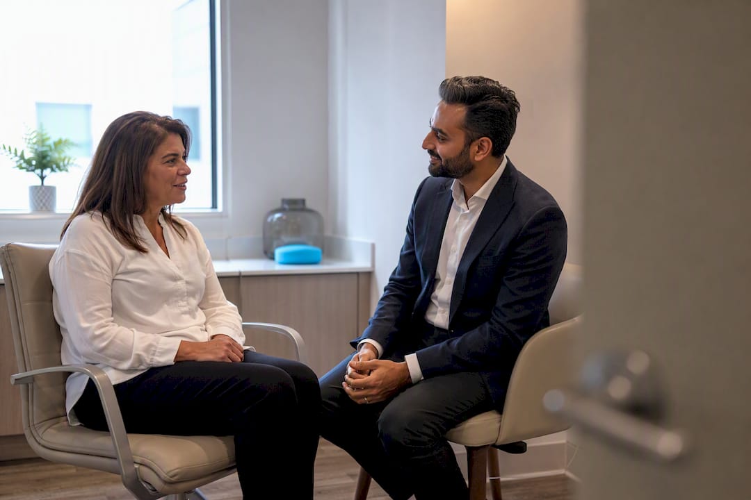 Patient discussing ear discomfort with practitioner