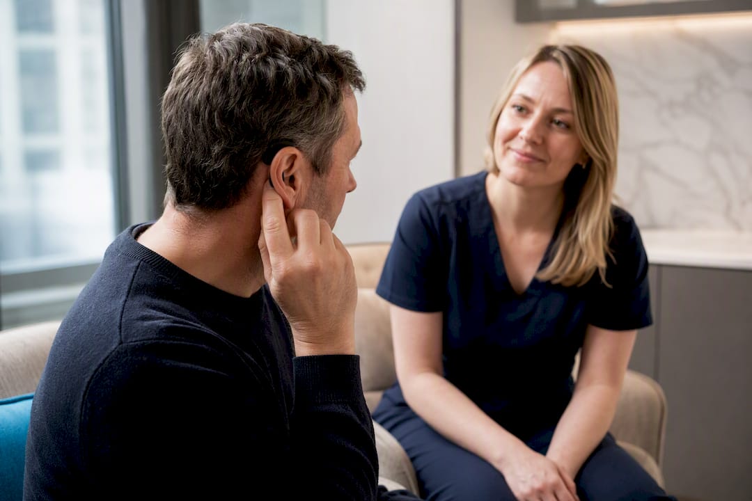 Adult discussing cochlear implant ear discomfort