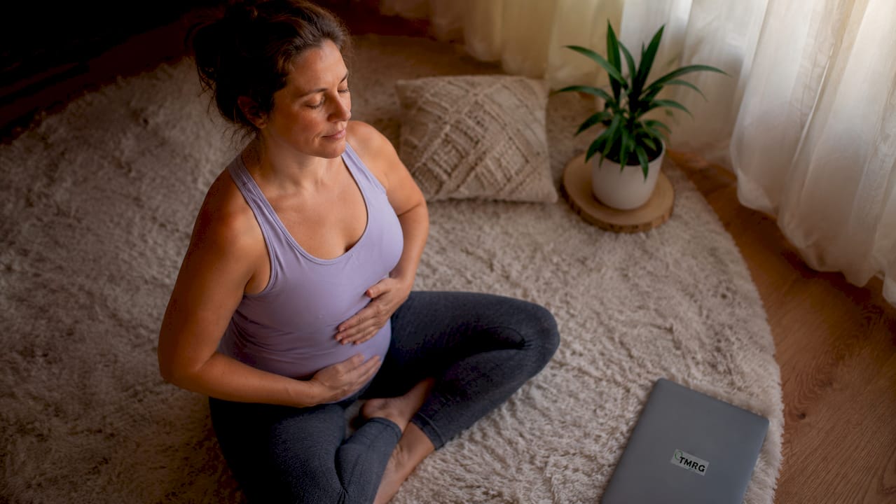 Woman practicing diaphragmatic breathing in yoga studio