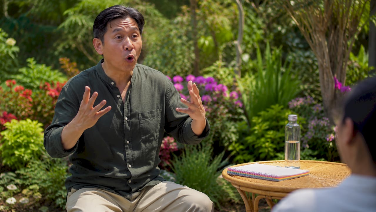 Vocal coach demonstrating warm-up routine at home