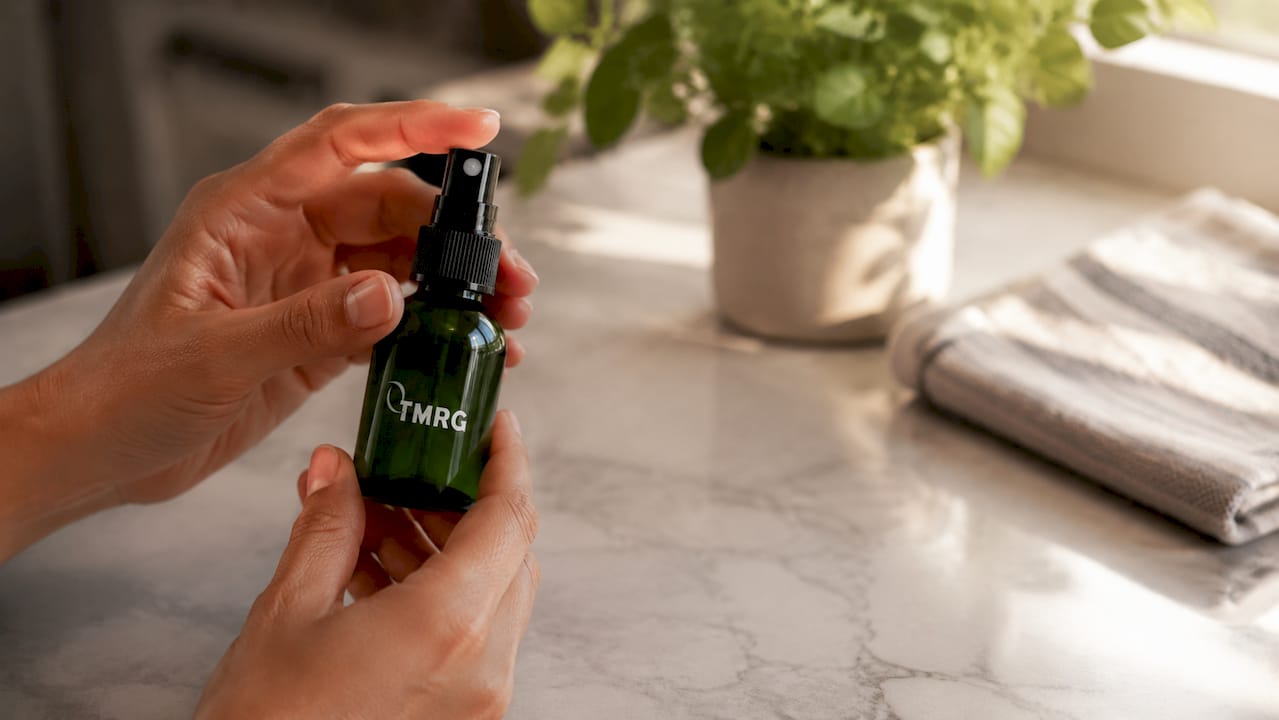 Hands holding herbal vocal spray bottle