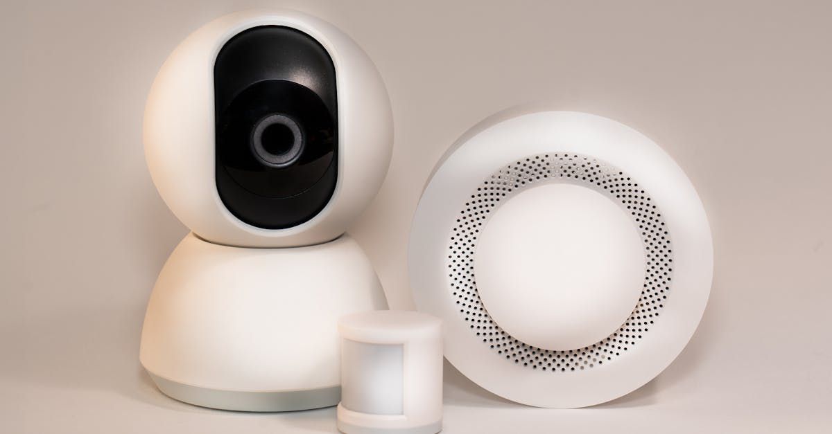 Homeowner installing smart smoke detector in hallway