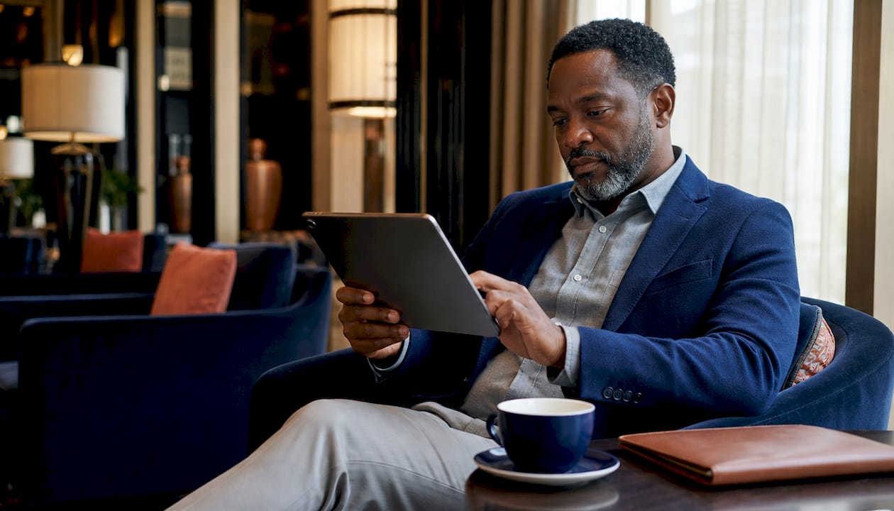 Man customizing travel itinerary on laptop
