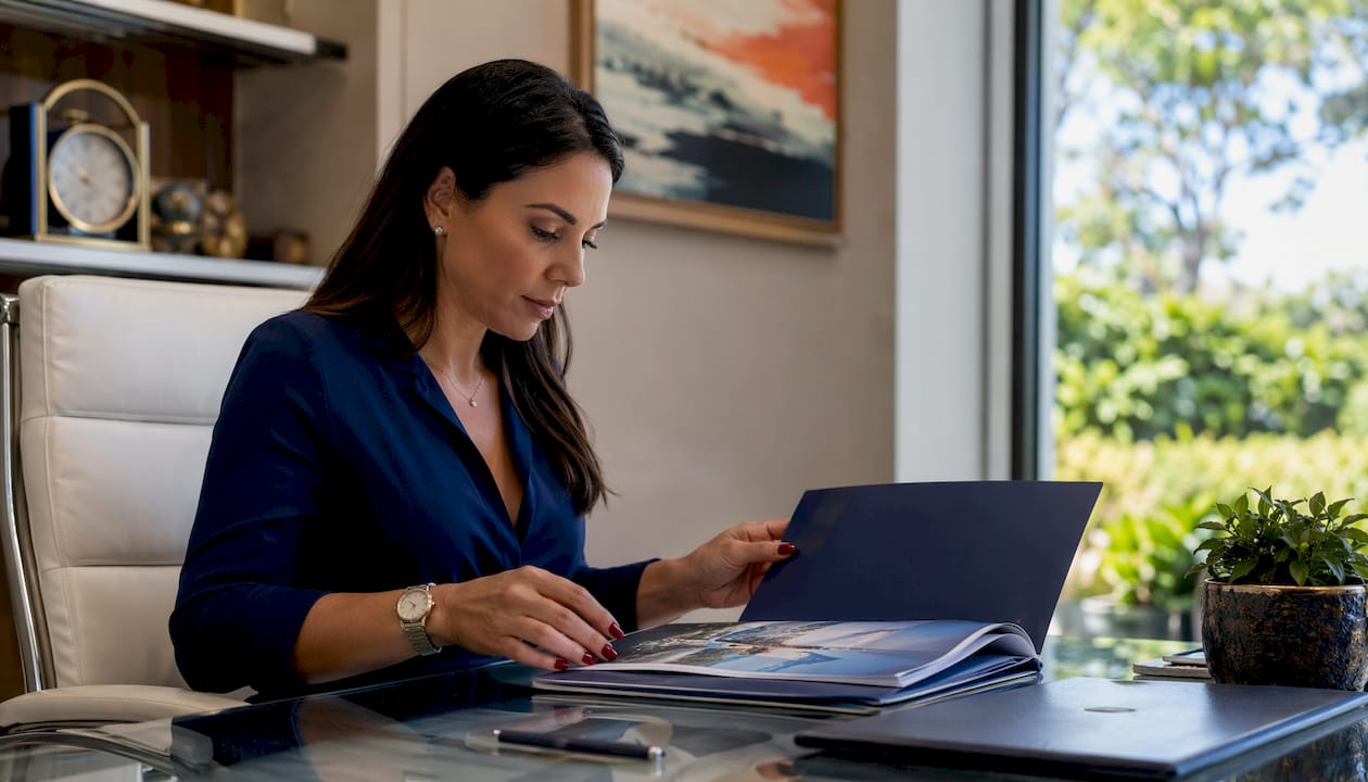Hands arranging exclusive honeymoon perks documents