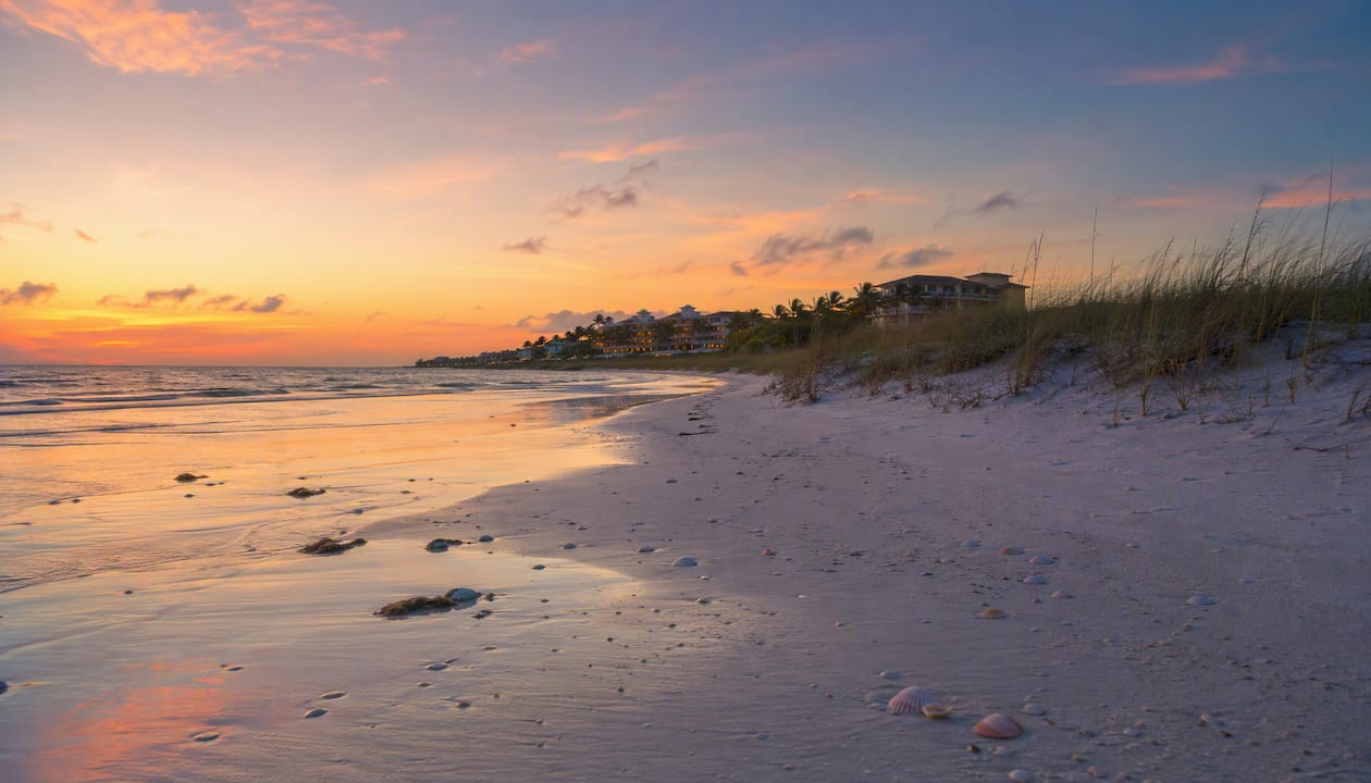 Tropical beach at sunset with calm water