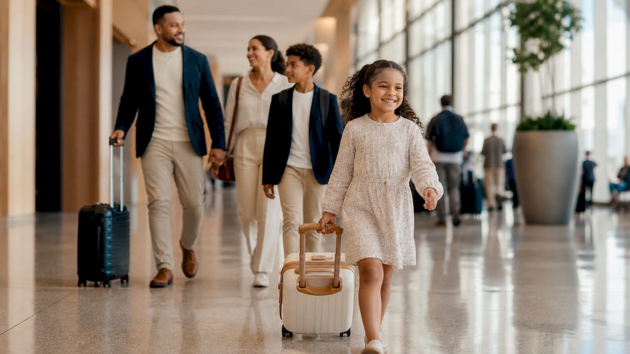 Child pulling suitcase in airport