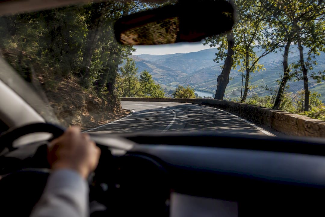 Scenic winding Douro Valley road from car perspective