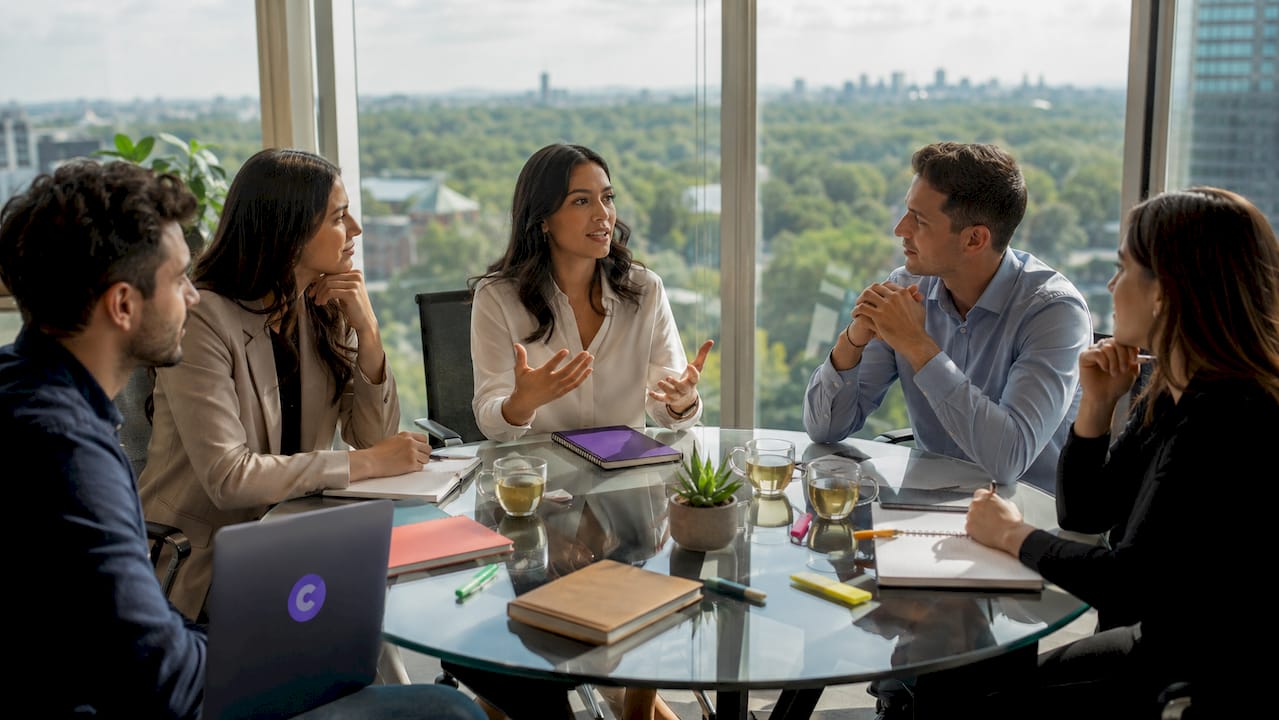 Group discussing feedback in modern office conference room