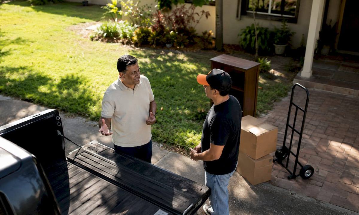 Customer and helper discussing hauling job outdoors