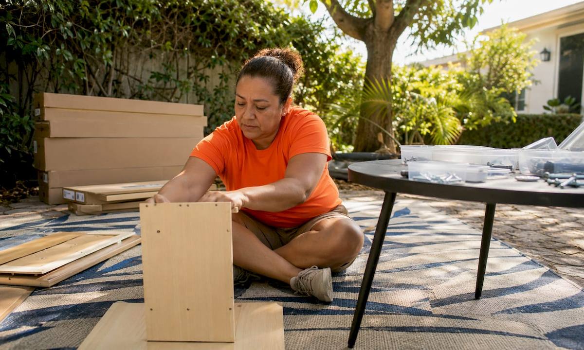Handyman assembling desk in garage