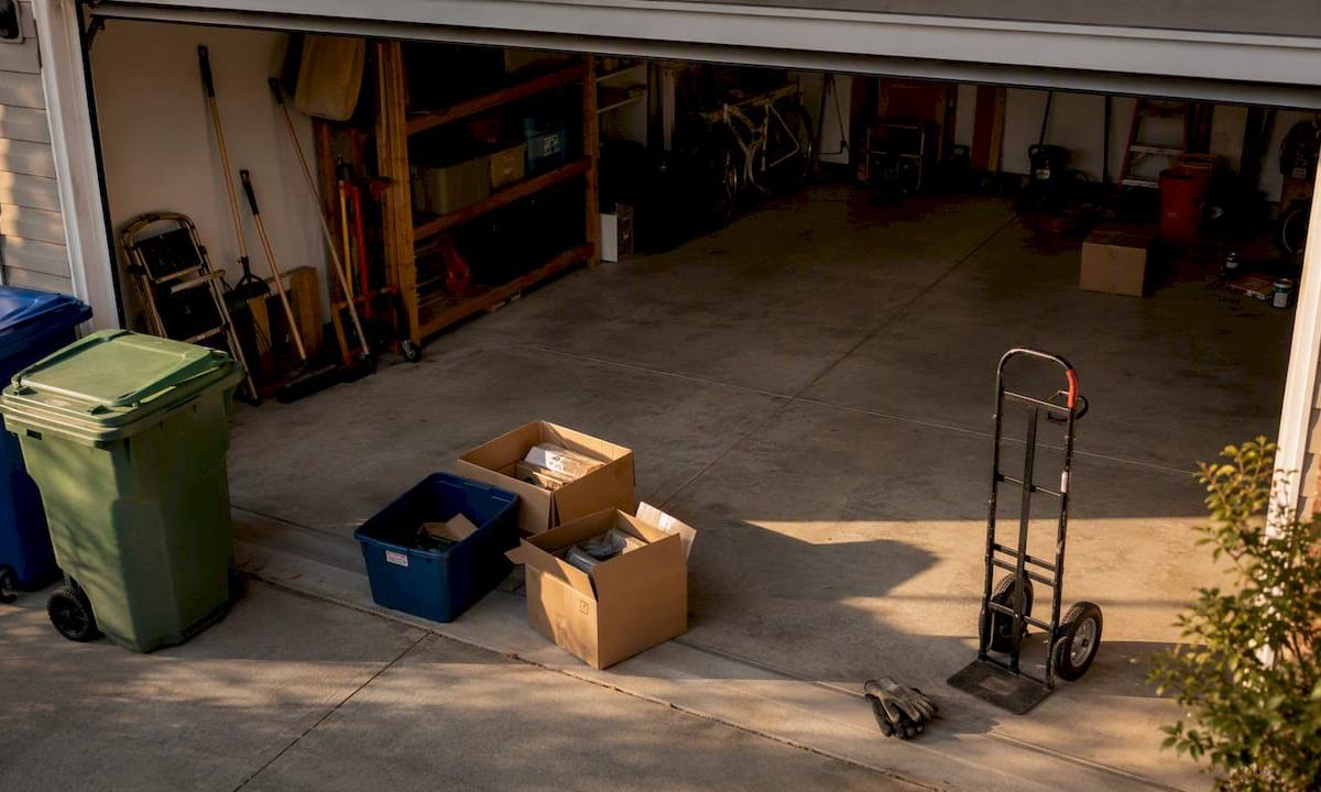 Empty garage with recycling bins and moving tools