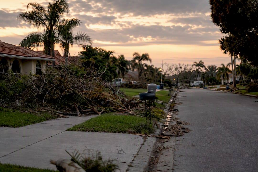 Street with leftover hurricane debris awaiting pickup