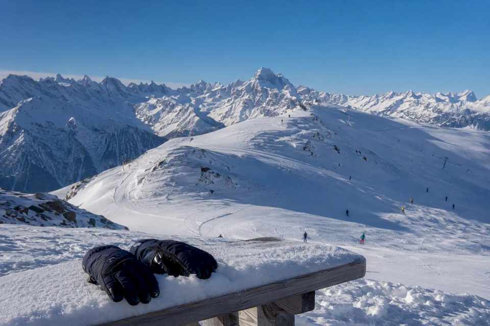 Panoramic view of an Alpine ski resort and snow-covered slopes