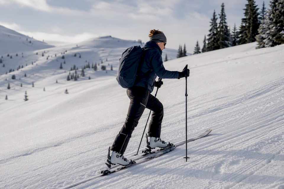 Ski tourer ascending a groomed skin track