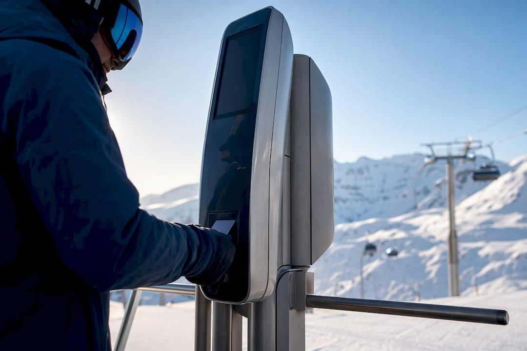 Skier approaching an alpine lift gate