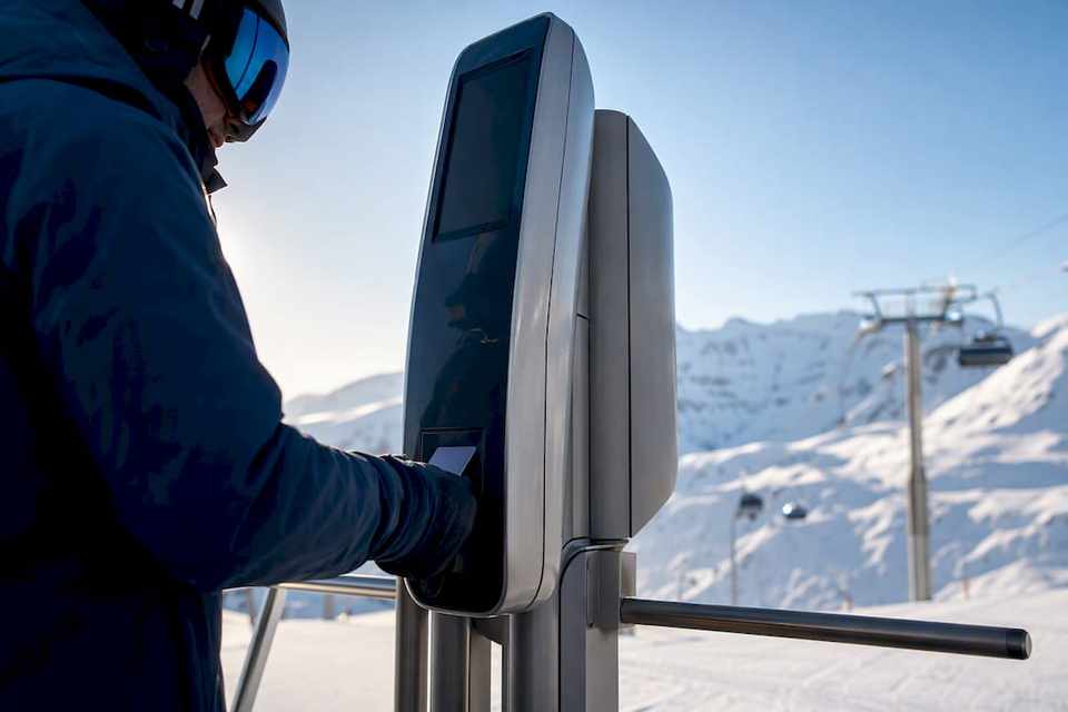 Skier approaching an alpine lift gate